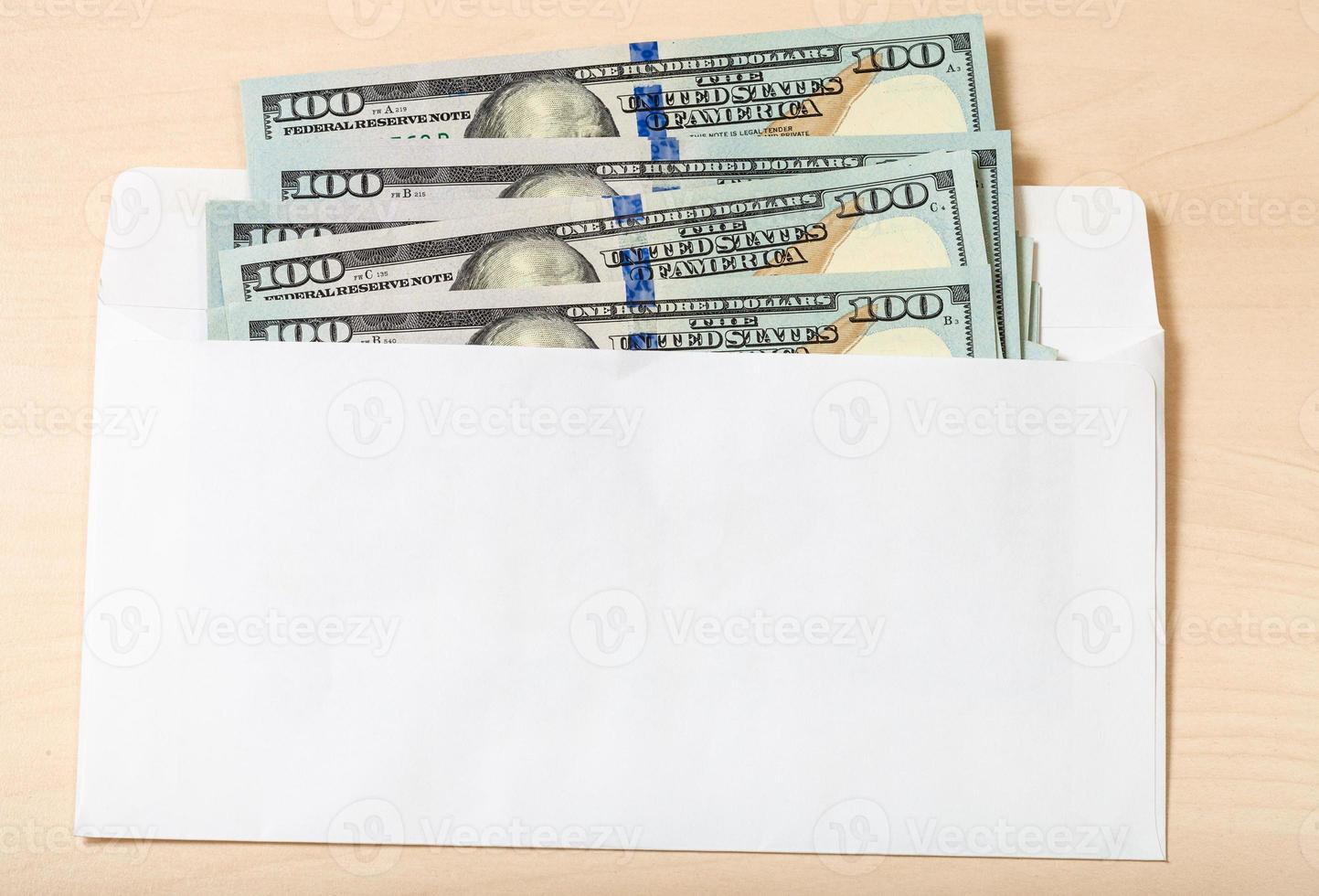 many one hundred dollar bills in envelope on table photo