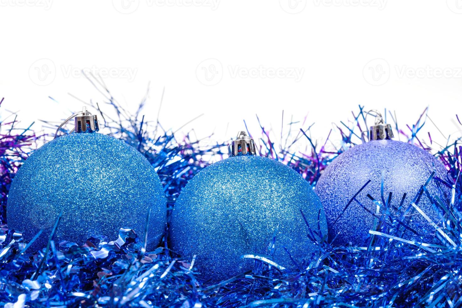few blue Christmas baubles and tinsel isolated photo