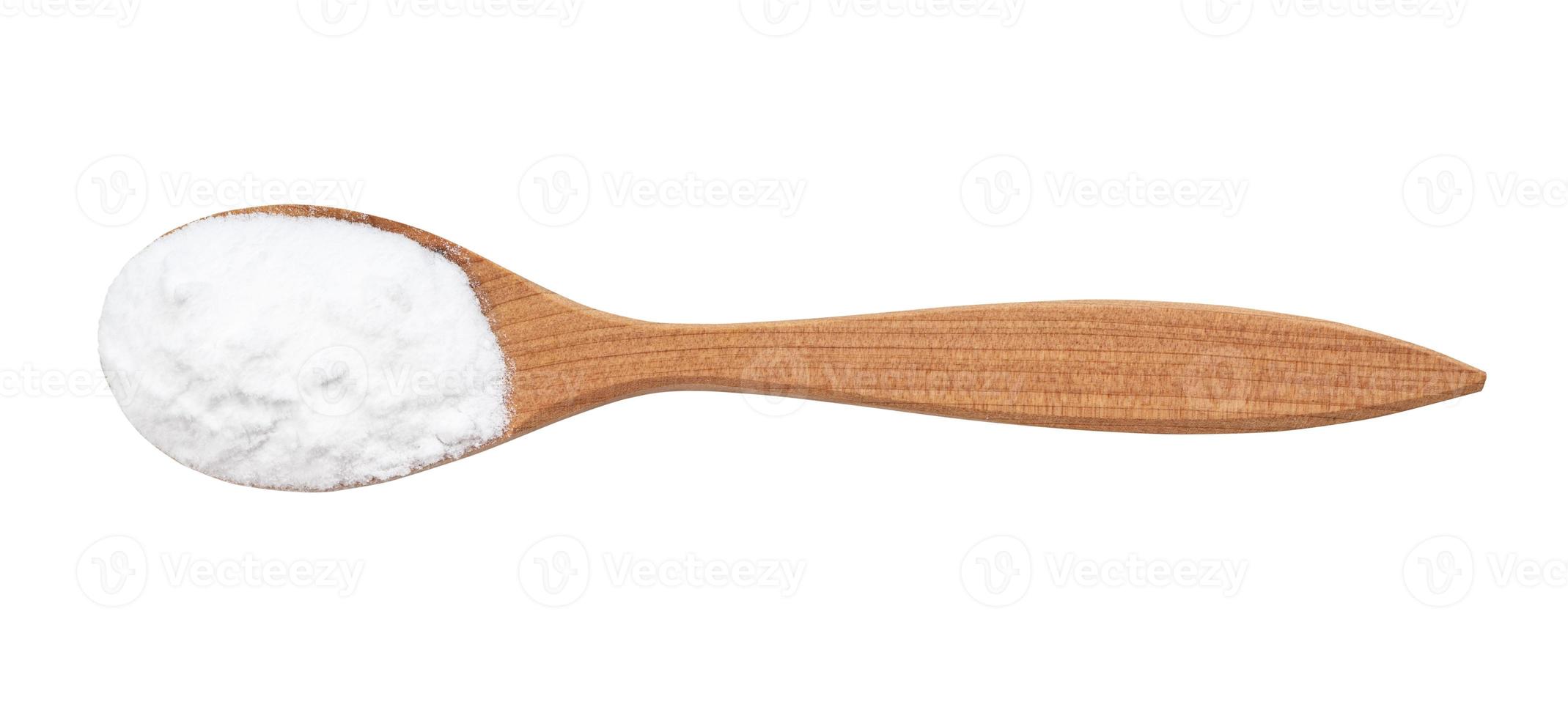 view of sodium bicarbonate in wood spoon isolated photo