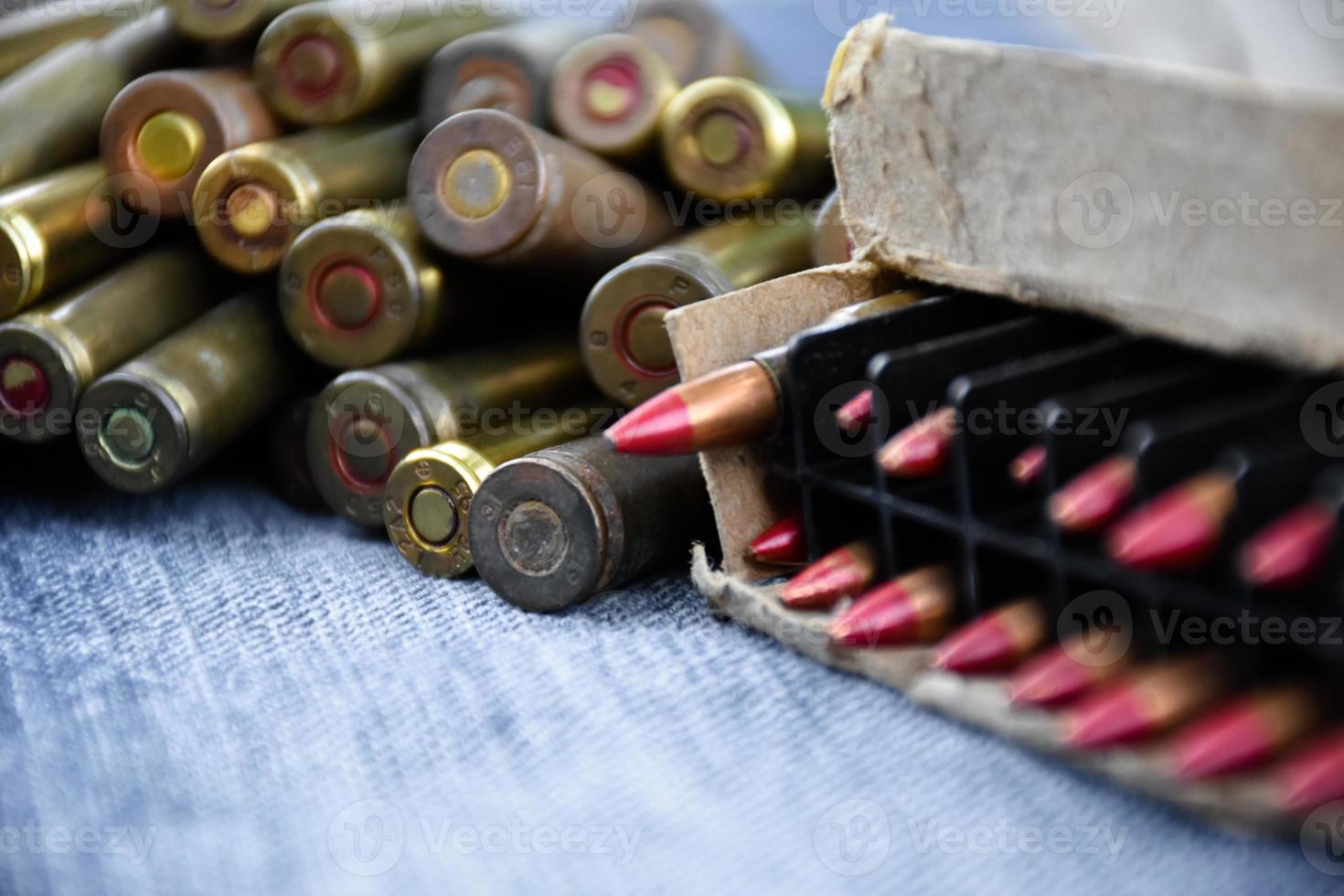 Closeup view of the old bullets on jeans floor, soft and selective focus on bullets, concept for collecting old bullets in free times. photo