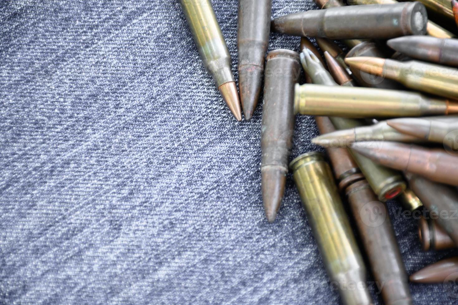 Closeup view of the old bullets on jeans floor, soft and selective focus on bullets, concept for collecting old bullets in free times. photo