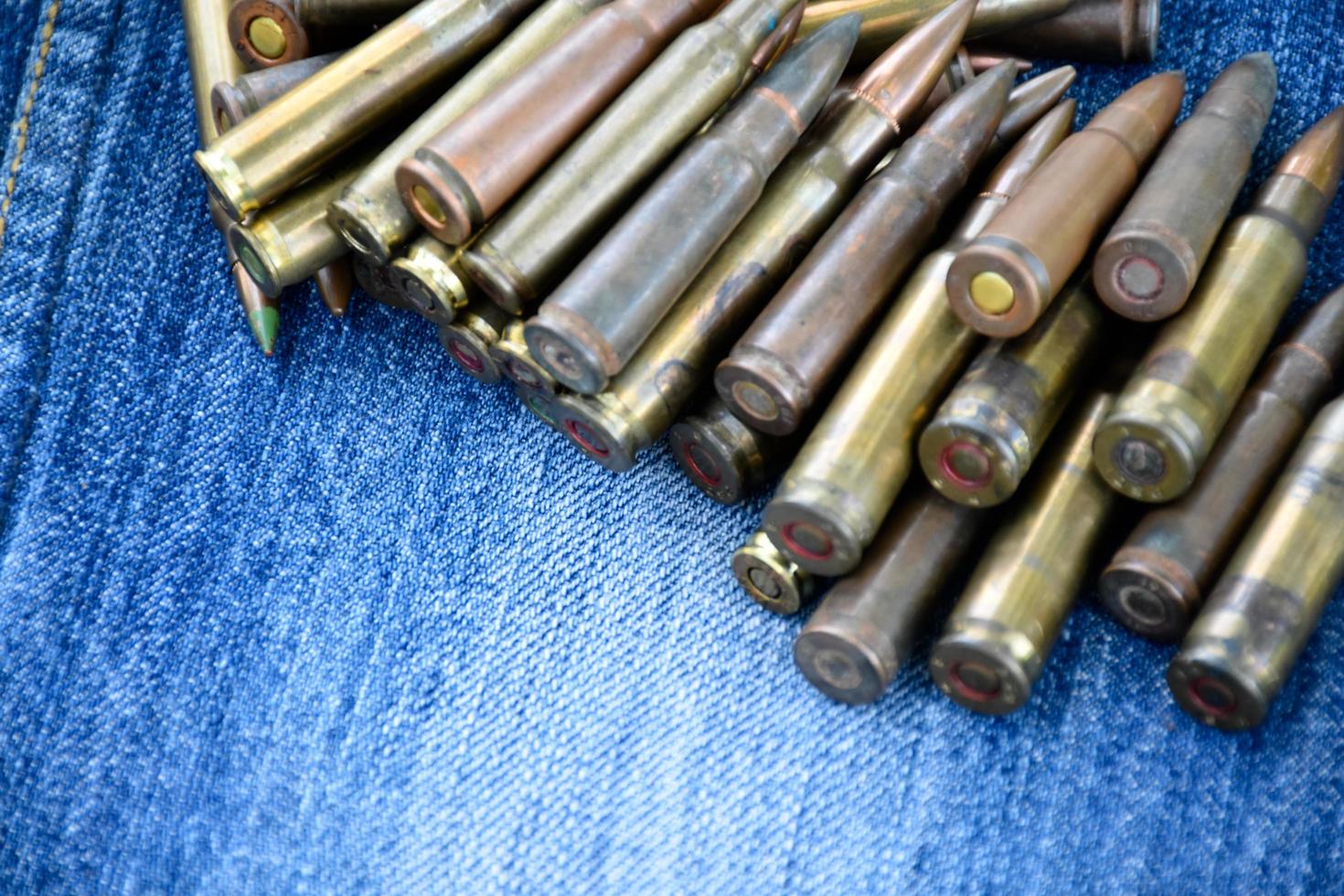 Closeup view of the old bullets on jeans floor, soft and selective focus on bullets, concept for collecting old bullets in free times. photo