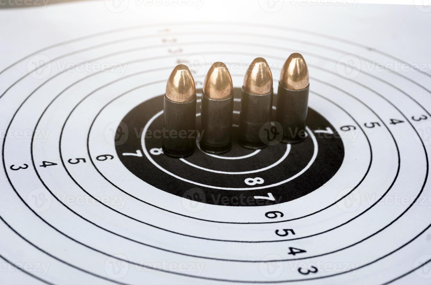 9mm pistol bullets on target shooting paper, soft and selectivec focus photo