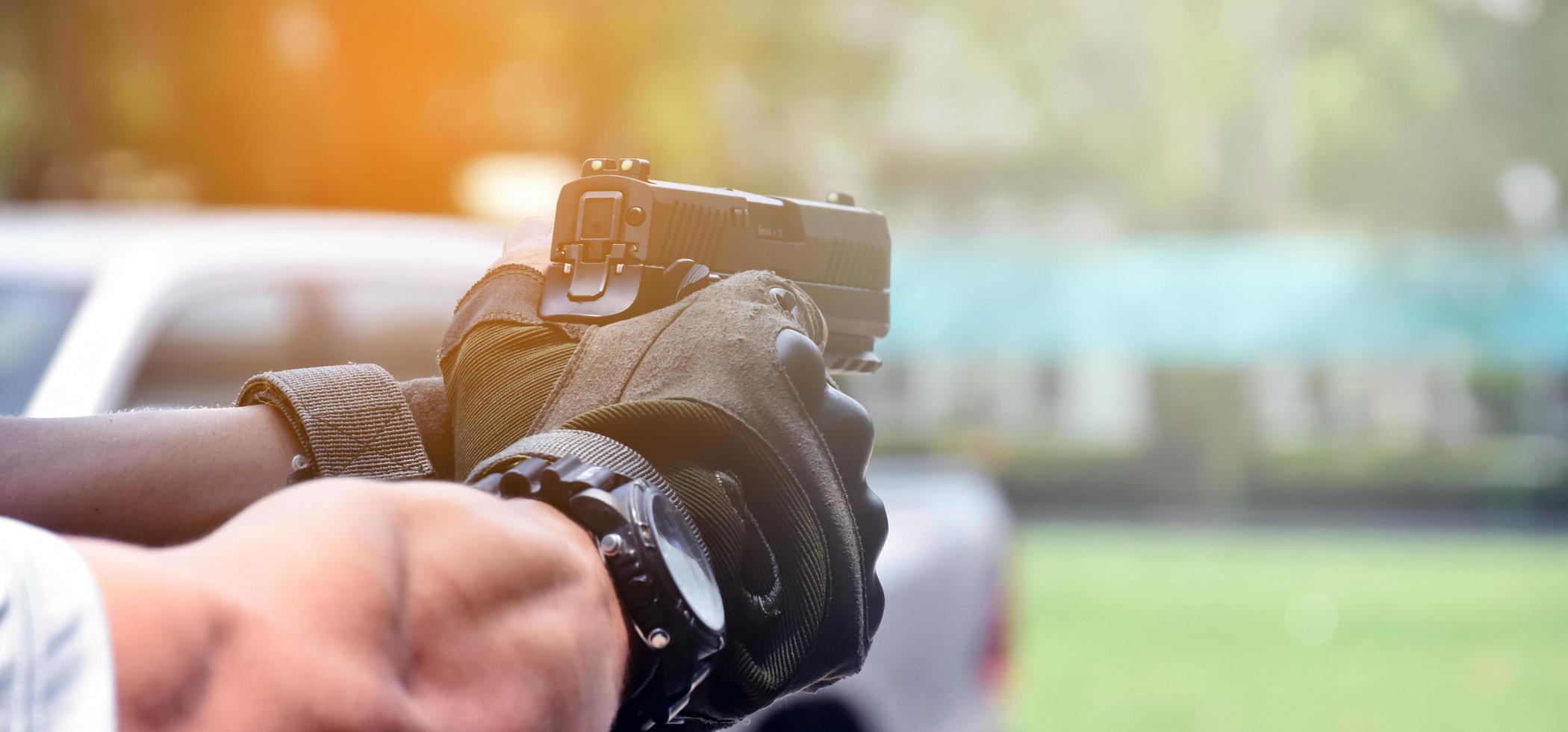 9mm automatic pistol holding in right hand of shooter, concept for security, robbery, gangster, bodyguard around the world. selective focus on pistol. photo