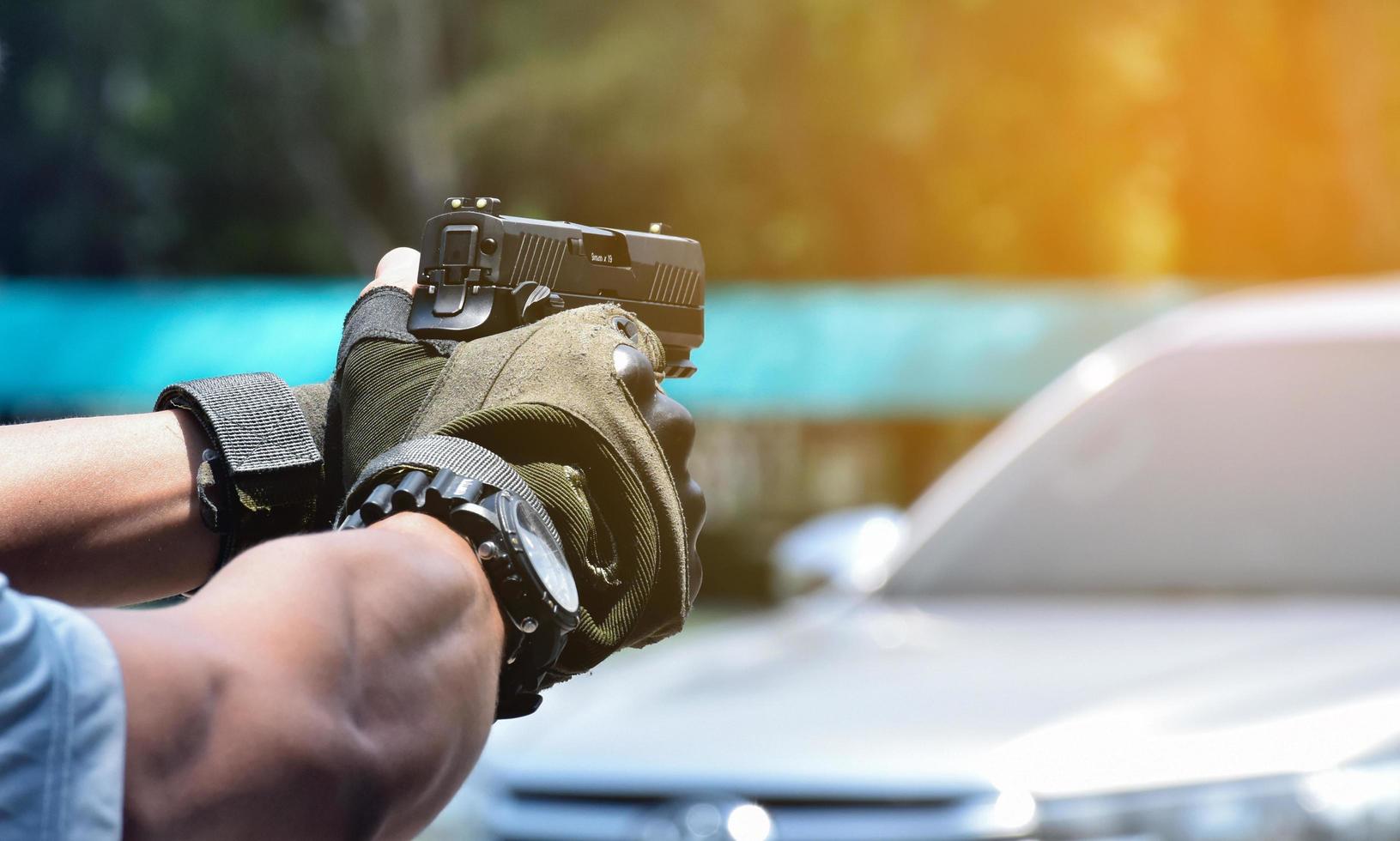 9mm automatic pistol holding in right hand of shooter, concept for security, robbery, gangster, bodyguard around the world. selective focus on pistol. photo