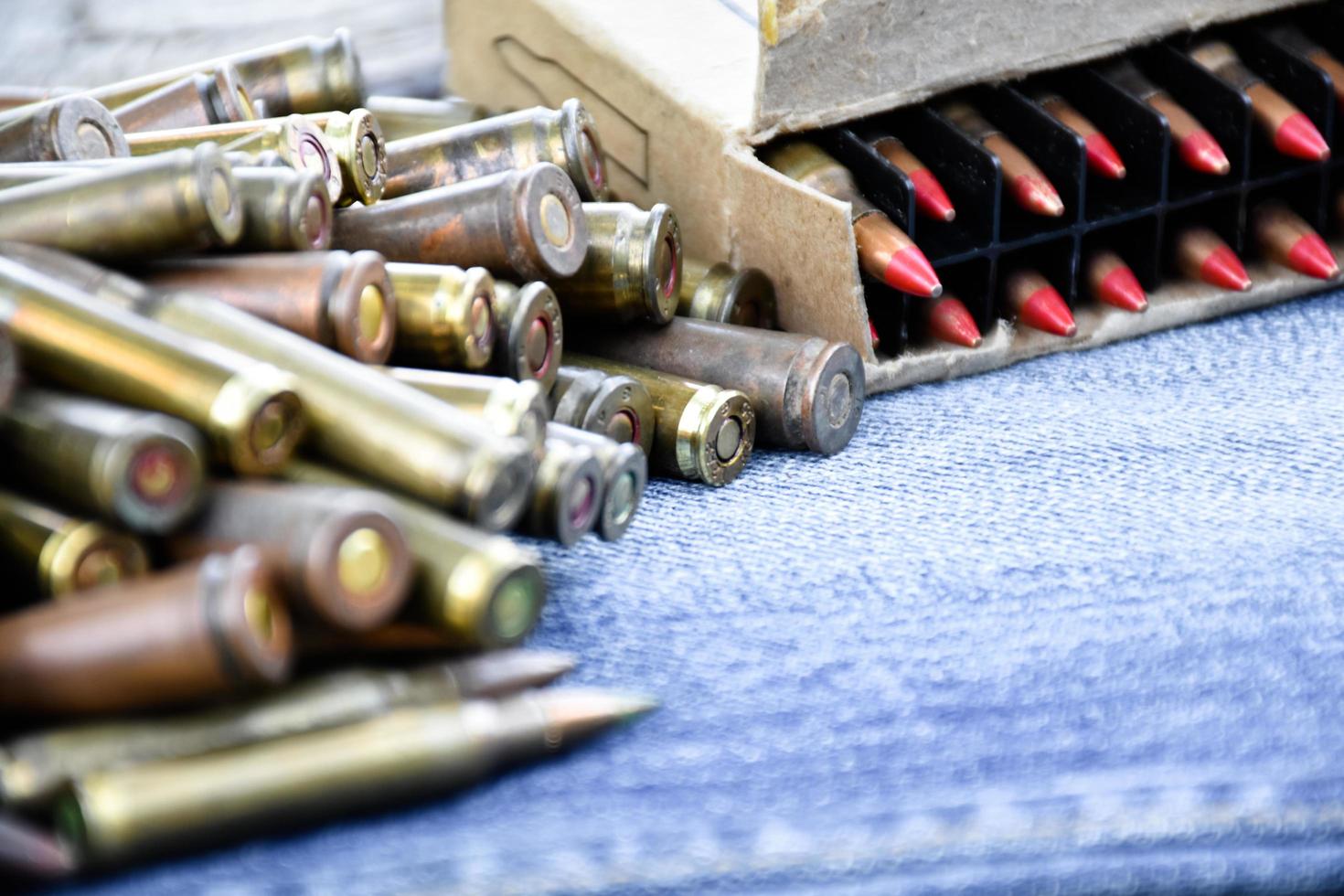 Closeup view of the old bullets on jeans floor, soft and selective focus on bullets, concept for collecting old bullets in free times. photo