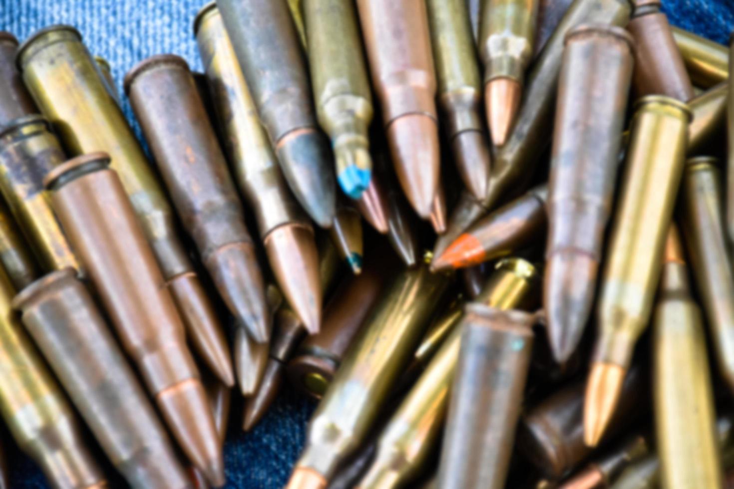 Closeup view of the old bullets on jeans floor, soft and selective focus on bullets, concept for collecting old bullets in free times. photo