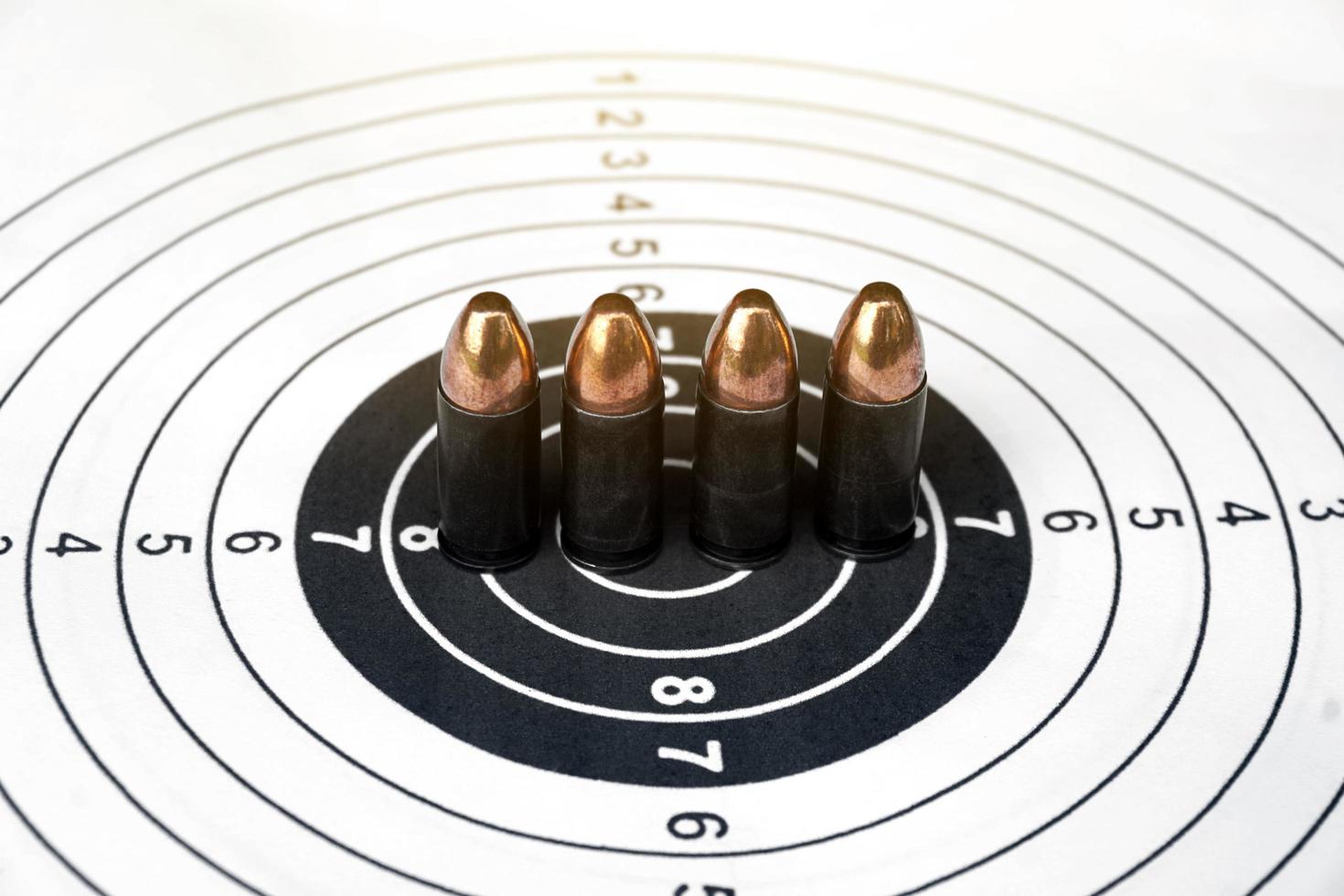 9mm pistol bullets on target shooting paper, soft and selectivec focus photo