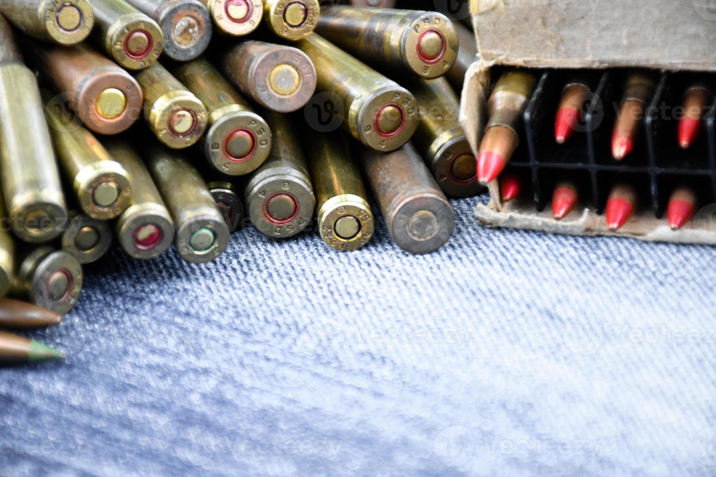 Closeup view of the old bullets on jeans floor, soft and selective focus on bullets, concept for collecting old bullets in free times. photo