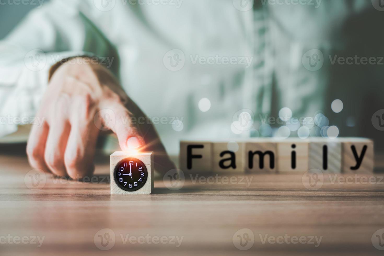 Businessman's hand moves a black clock icon on a wooden cube block forward. Time Management Ideas for Work and Family. photo