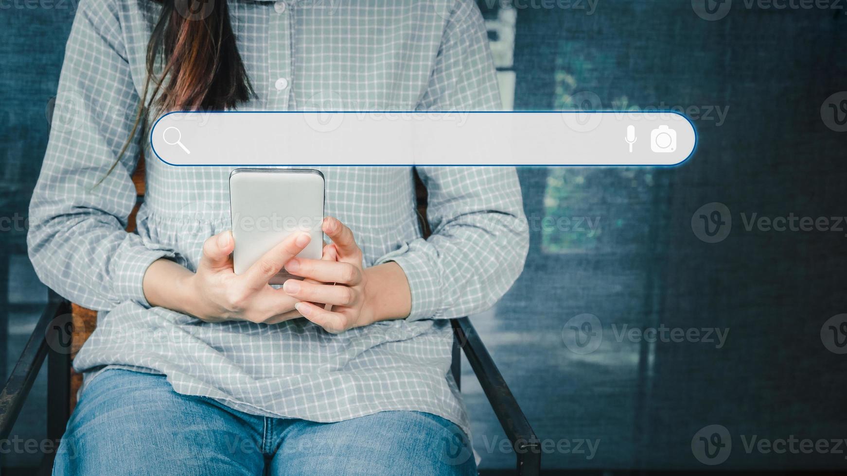Adult woman using smartphone in the cafe for searching browsing internet data information. Business concept for Using search with your website. photo