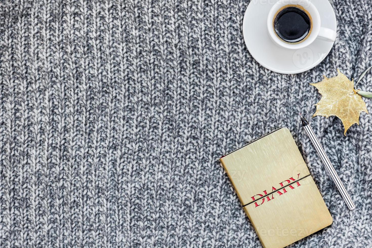 Home workplace with coffee cup on knitted plaid photo