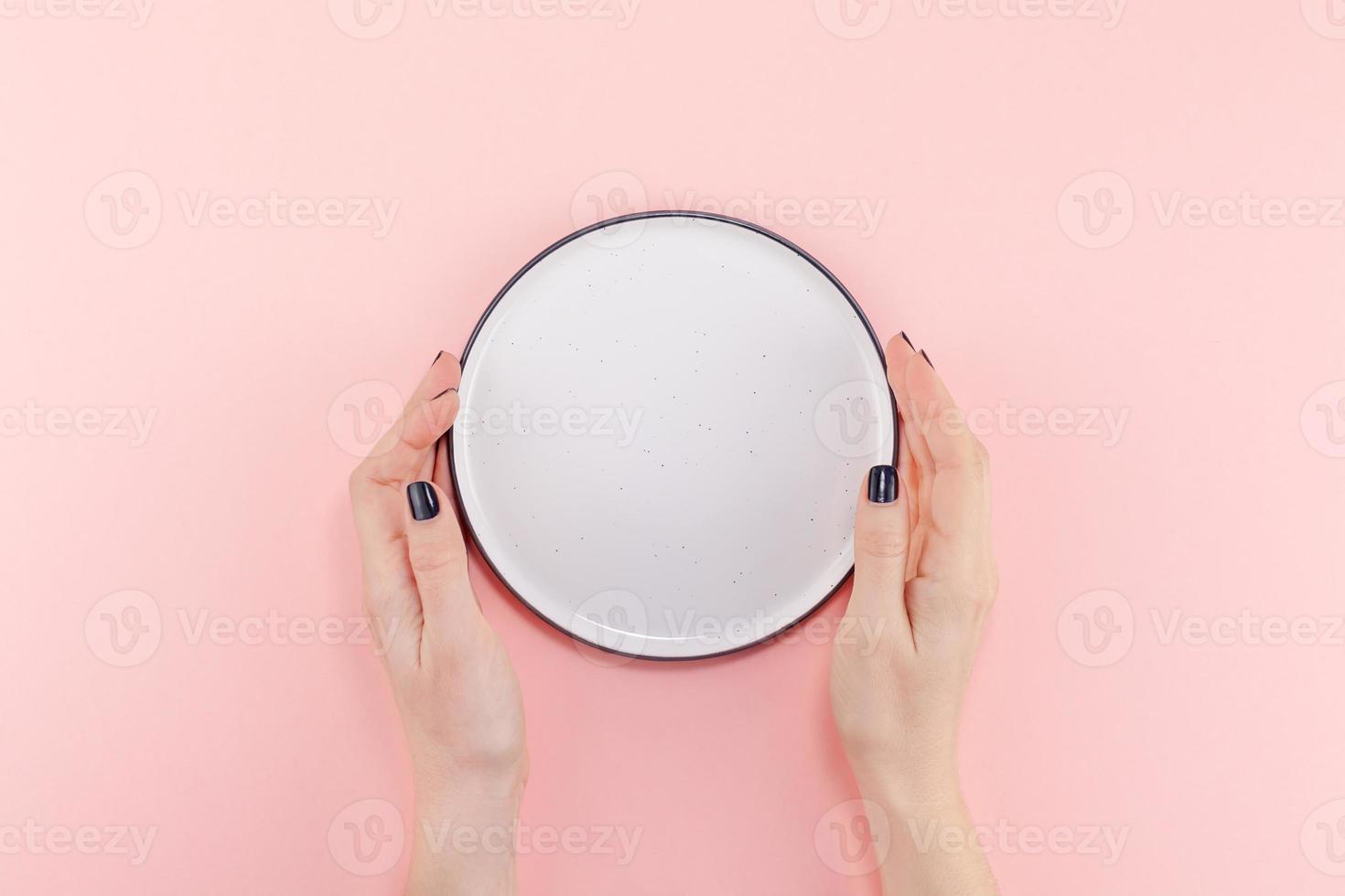 Empty plate in female hands mockup photo