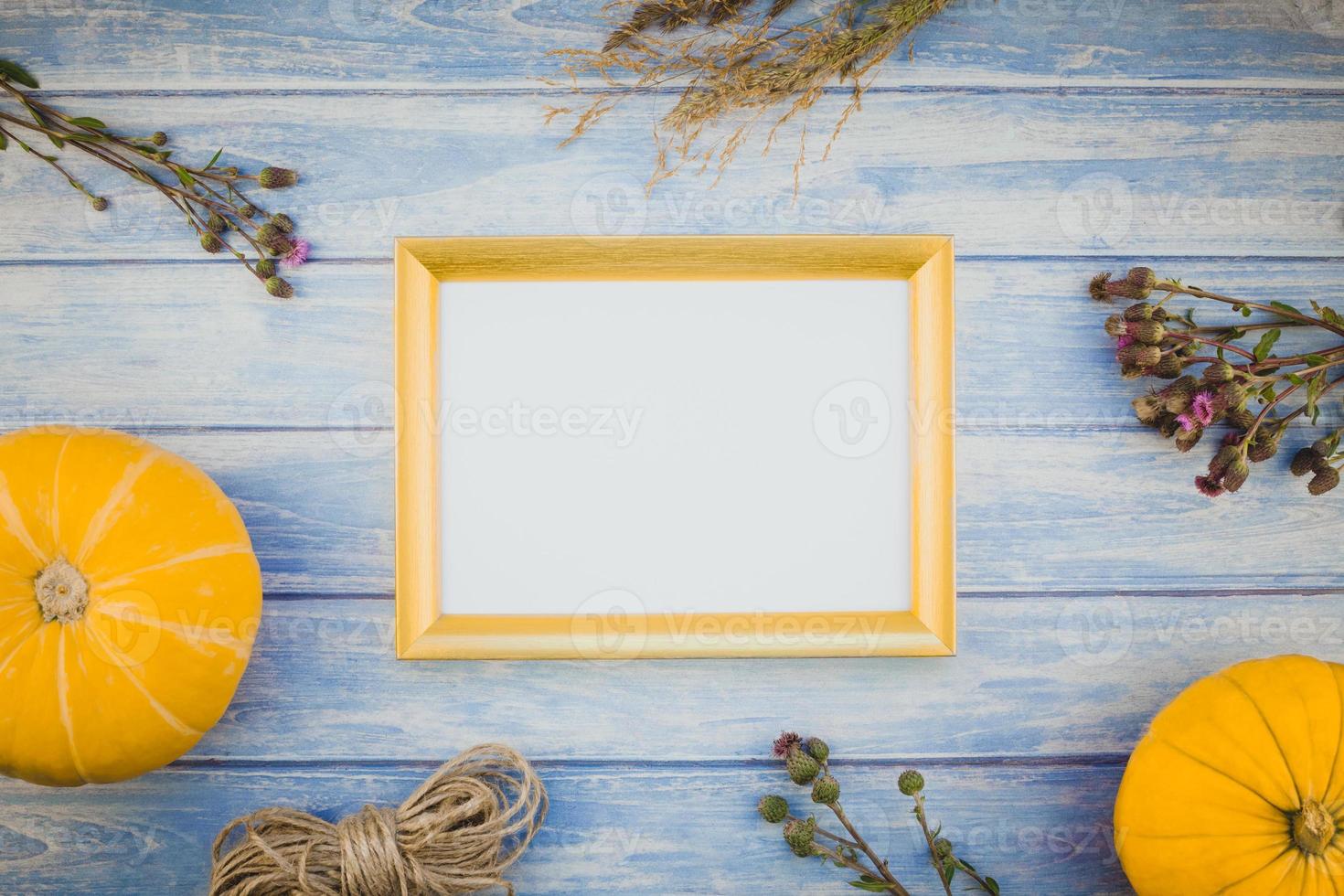 Golden frame mock up with autumn pumpkins photo