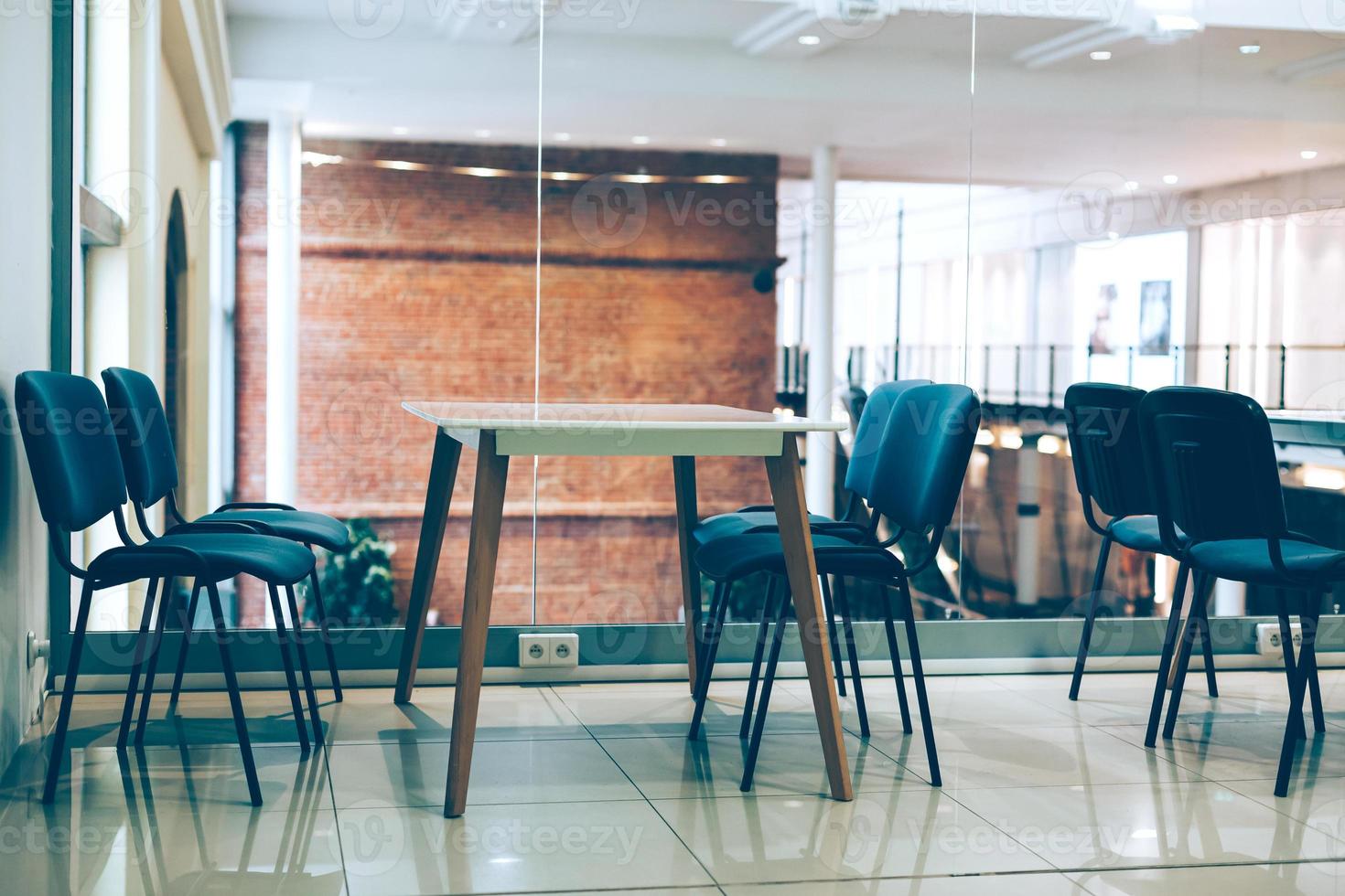Coworking room space with tables and chairs photo