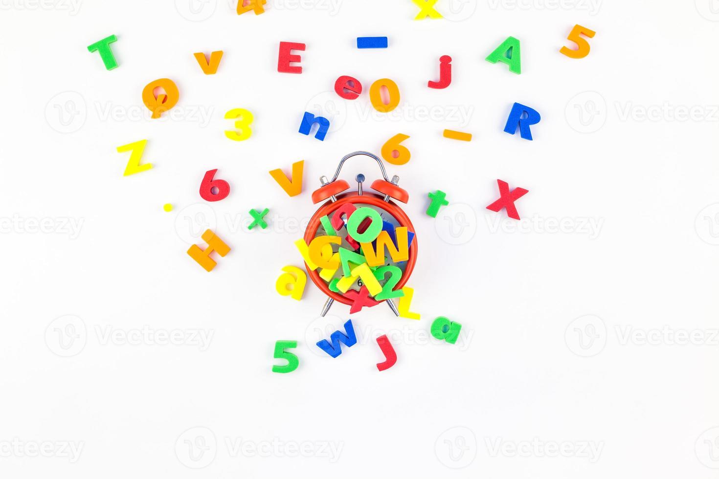 Alarm clock and multicolor alphabet photo
