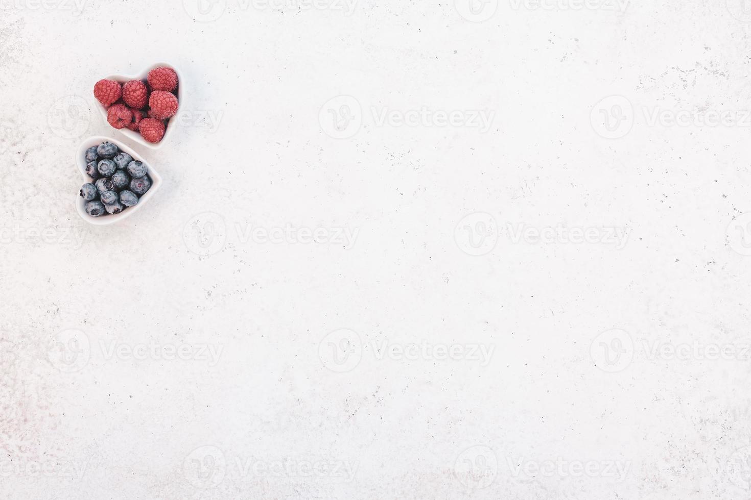 Valentine Day composition berries in heart plates photo