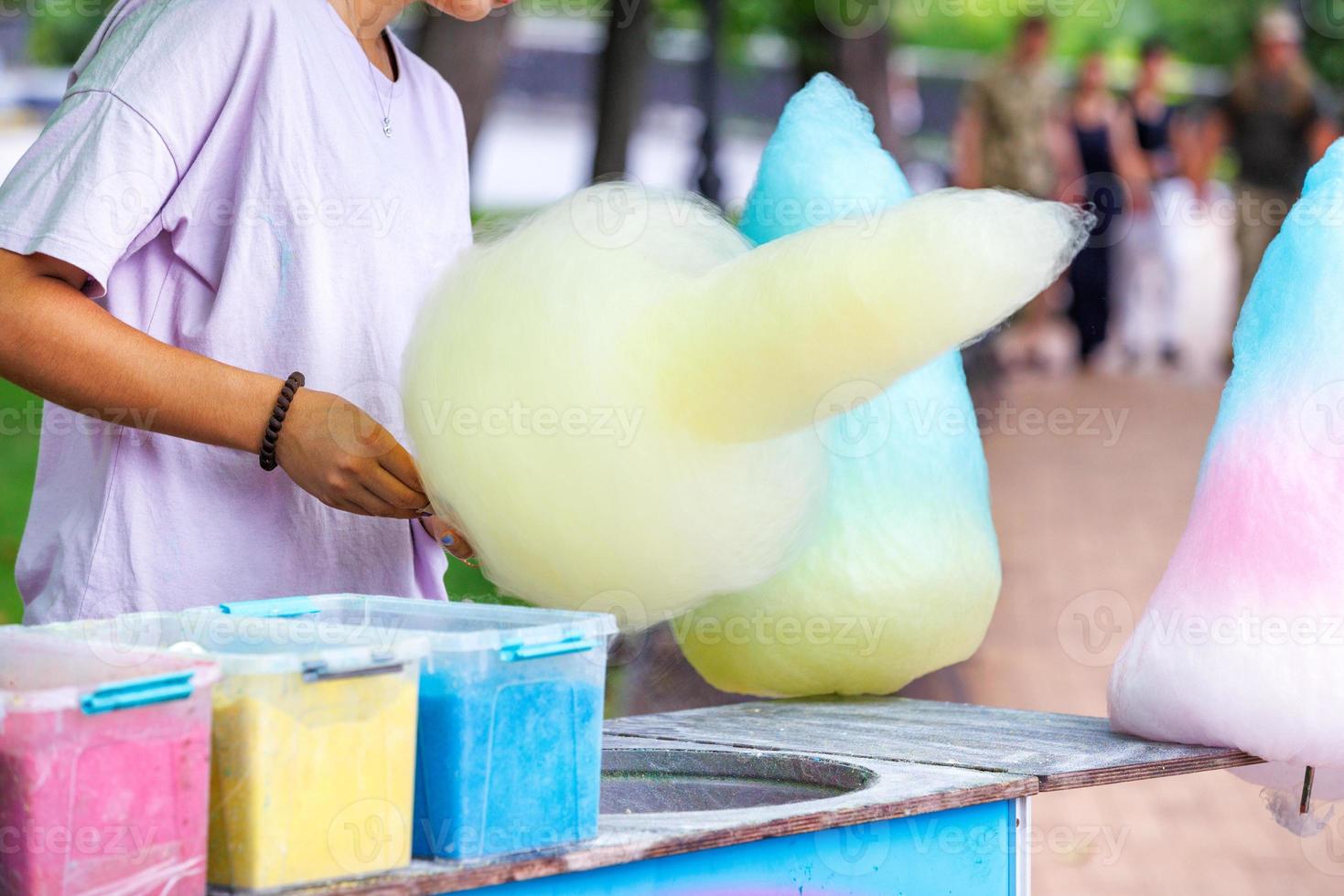 Cones of colorful cotton candy in a summer park on a blurred background. photo