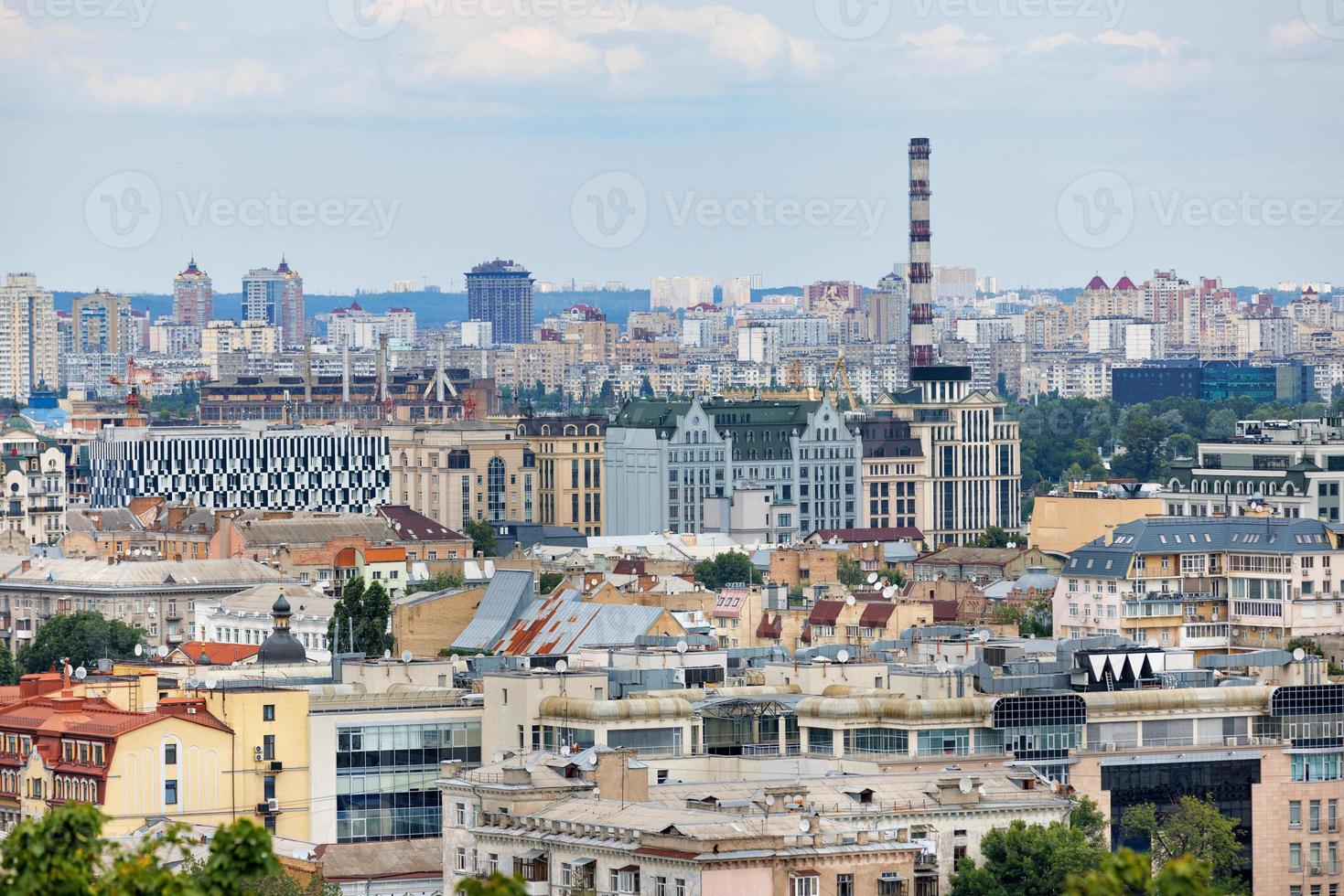 Urban rooftops of old and new residential areas under construction on a summer day. photo