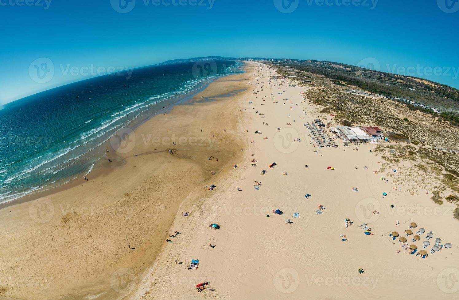 Aerial view of Caparica Beach in Almada District, Greater Lisbon, Portugal on a summer day photo