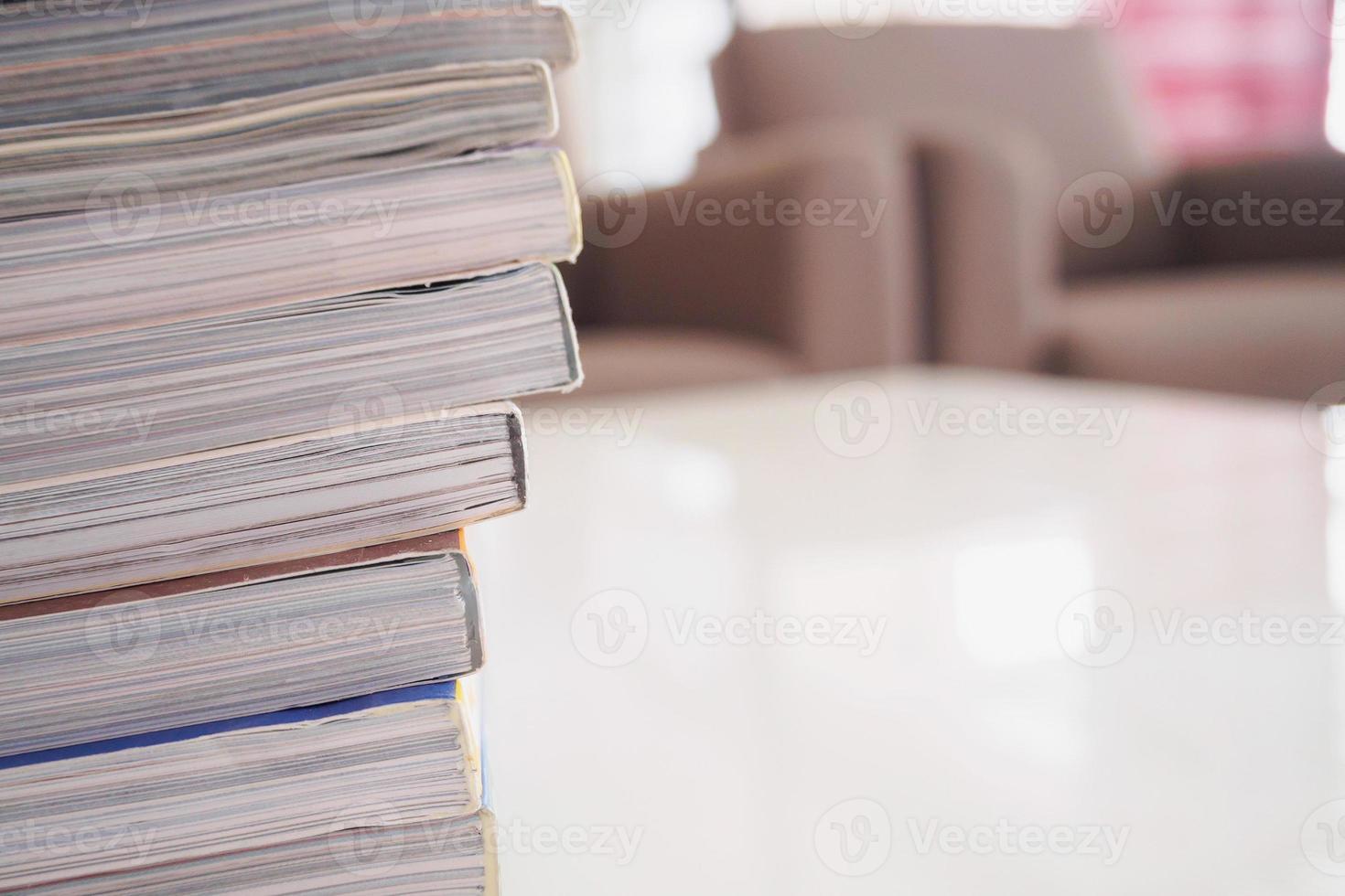 pile of magazines stack on white table in living room photo