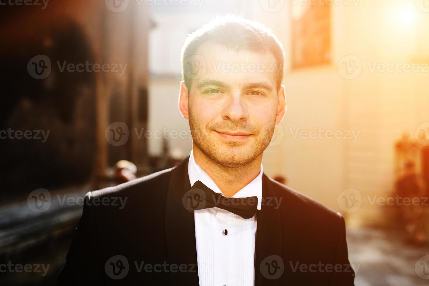 Handsome groom posing for the portrait photo