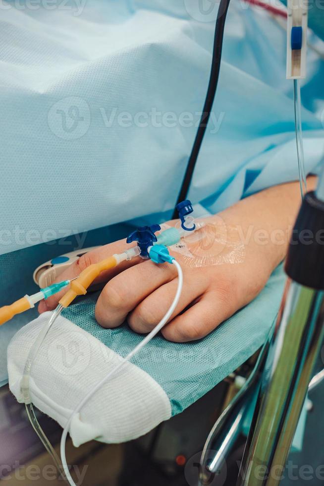 Close up of an drip in patient's hand, photo