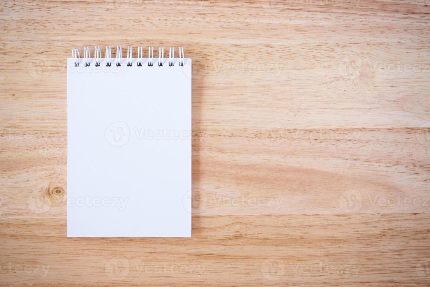 Notepad on the wooden desk table photo