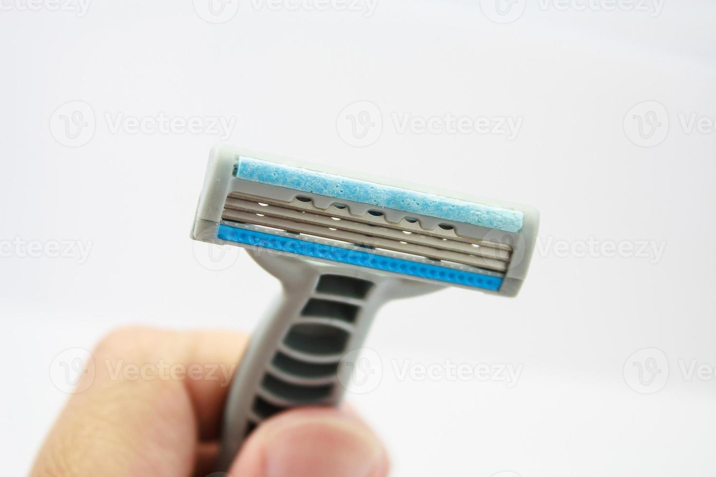 Hand with shaving razor isolated on a white background photo