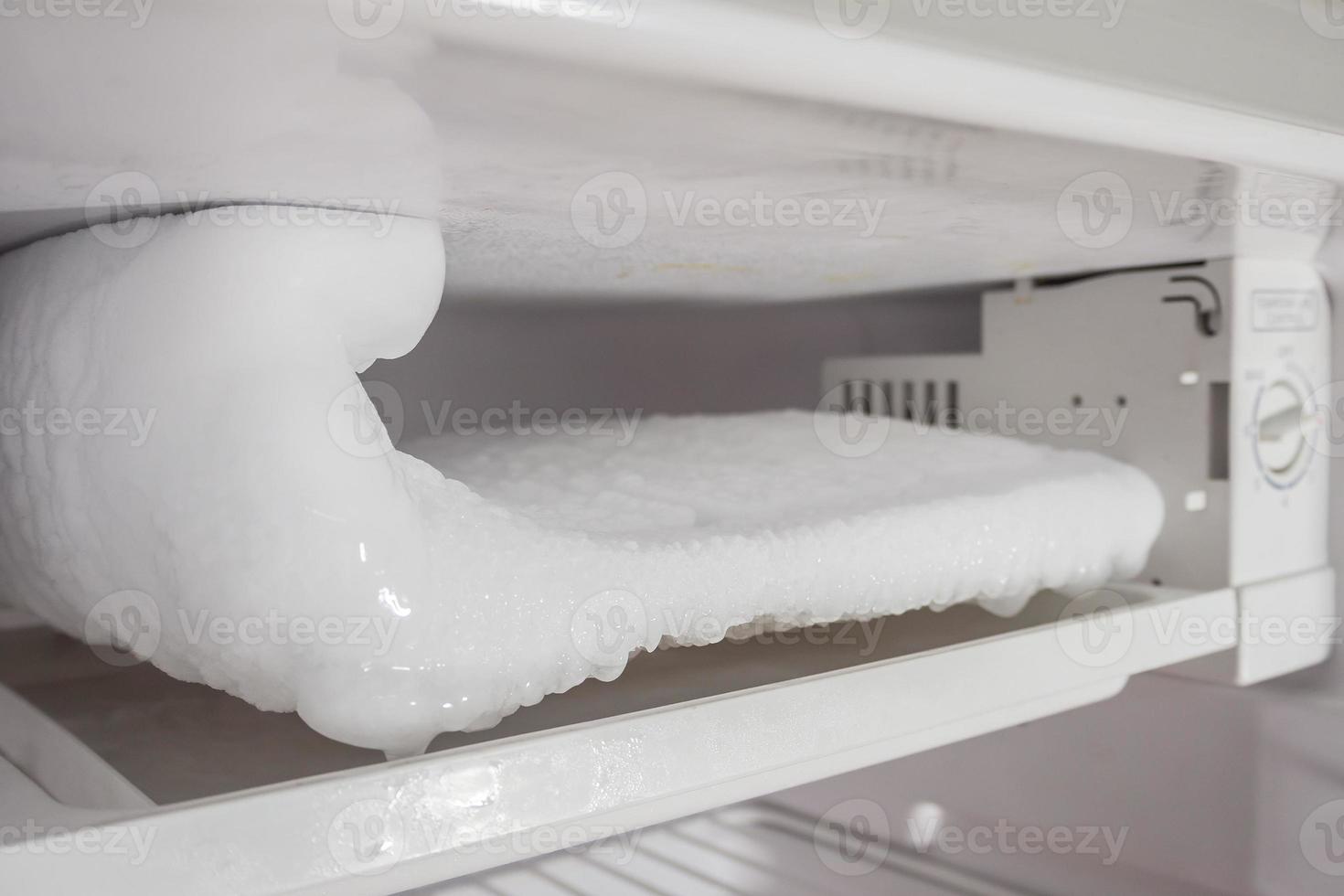 frozen Ice buildup in the freezer of refrigerator photo