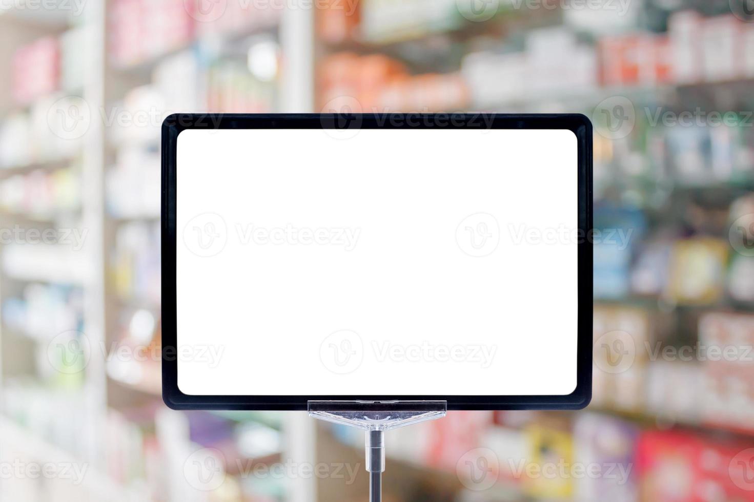 Blank price board sign display in Pharmacy blur background with medicine on shelves photo