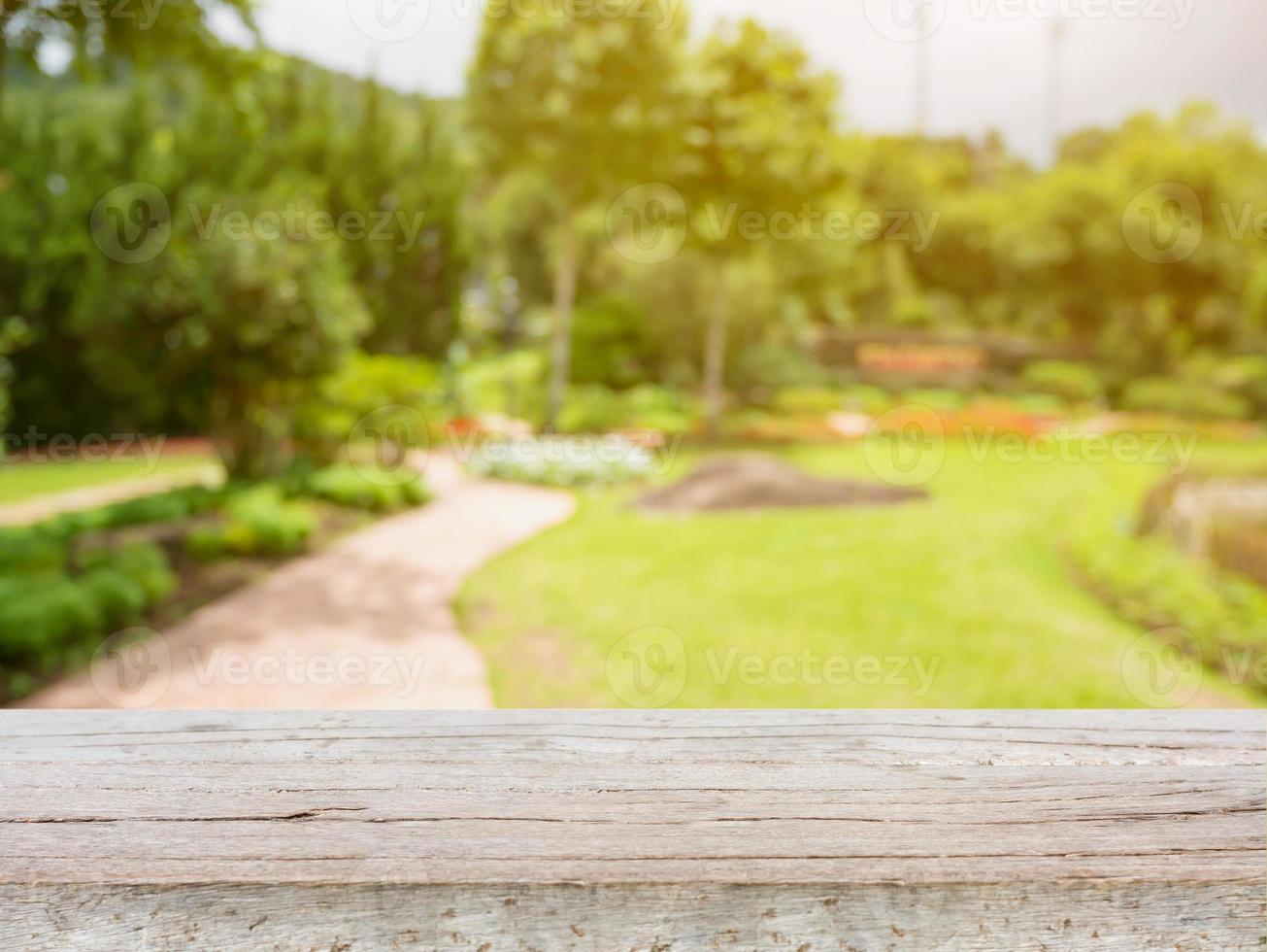 empty wood table with blurred garden park natural background photo