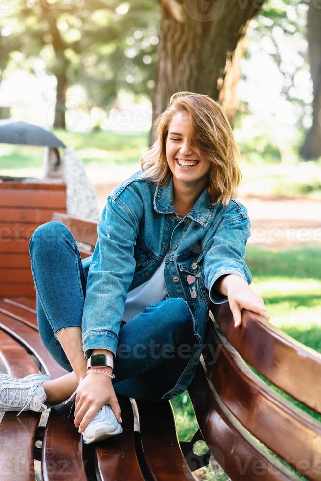 brunette woman on a bench at the pack photo