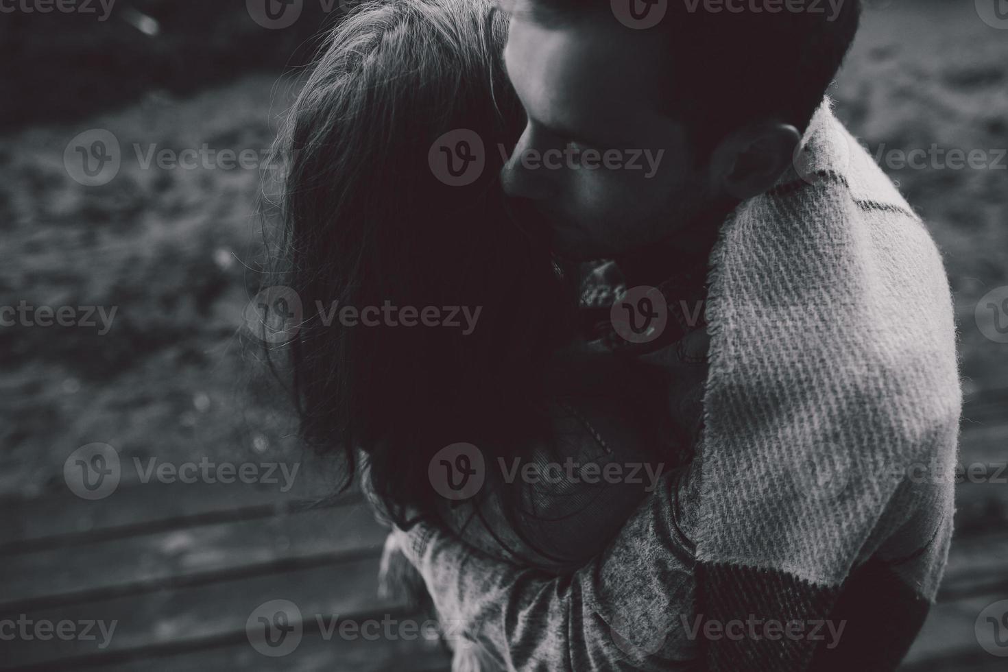 Young couple wrapped in plaid outfocus photo