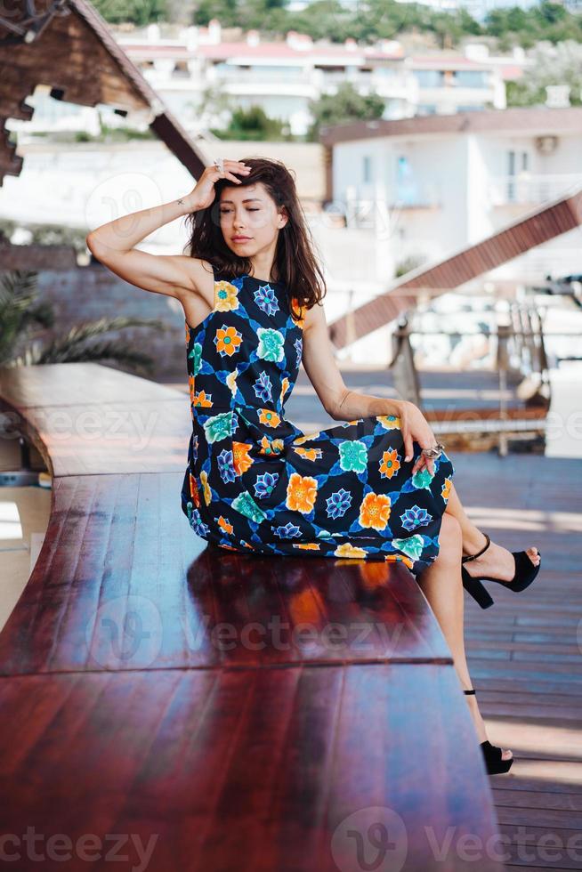 Brunette dress sitting on bench photo