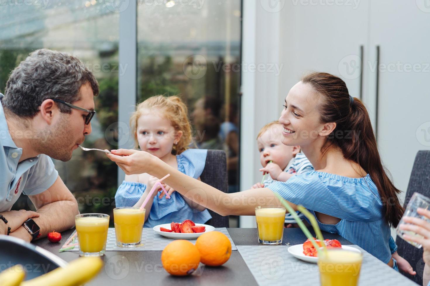 Happy family eating fresh fruit breakfast photo