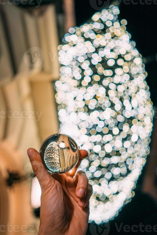 A glass ball in the background of a garland photo