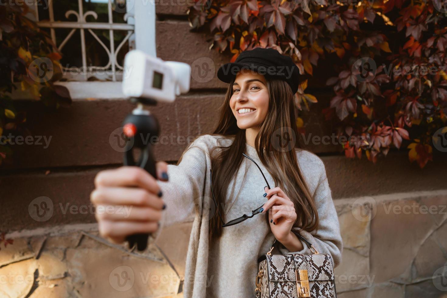 Cute, young girl makes selfie and posing on camera. photo