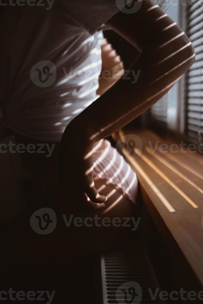 Young woman near the window in the morning photo