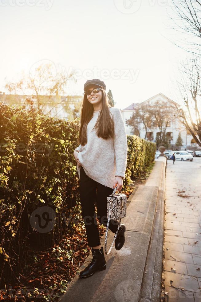 Street portrait of young beautiful fashionable woman photo