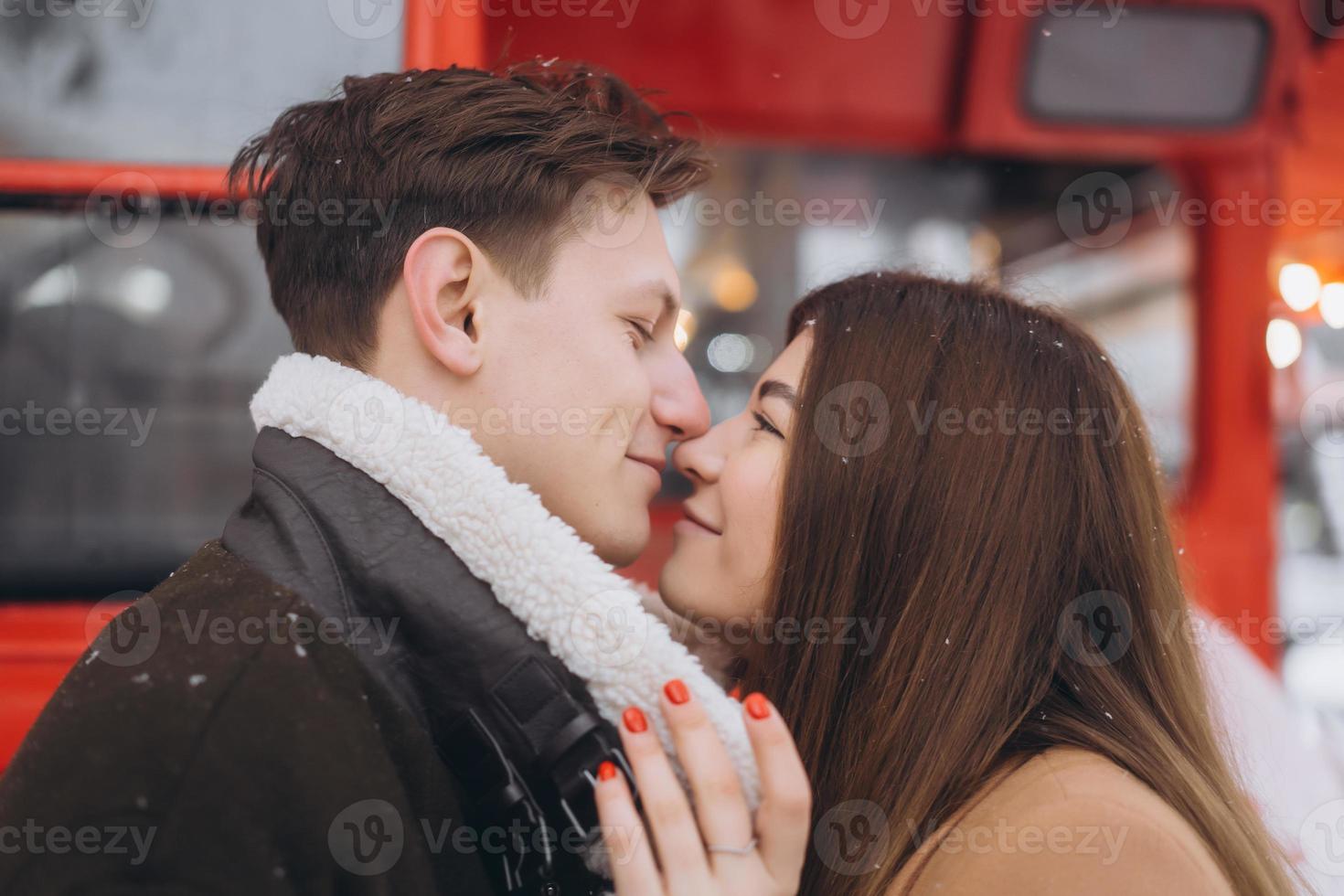 beautiful young couple posing by the old bus photo