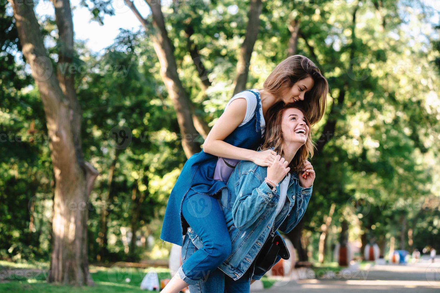 Beautiful women having fun in the park. Friends and summer concept. photo