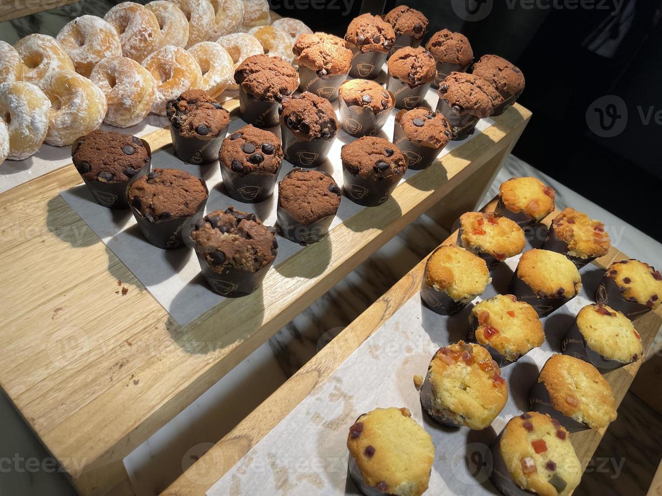 Lines of delicious chocolate and vanilla muffins Freshly baked homemade chocolate chip muffins photo