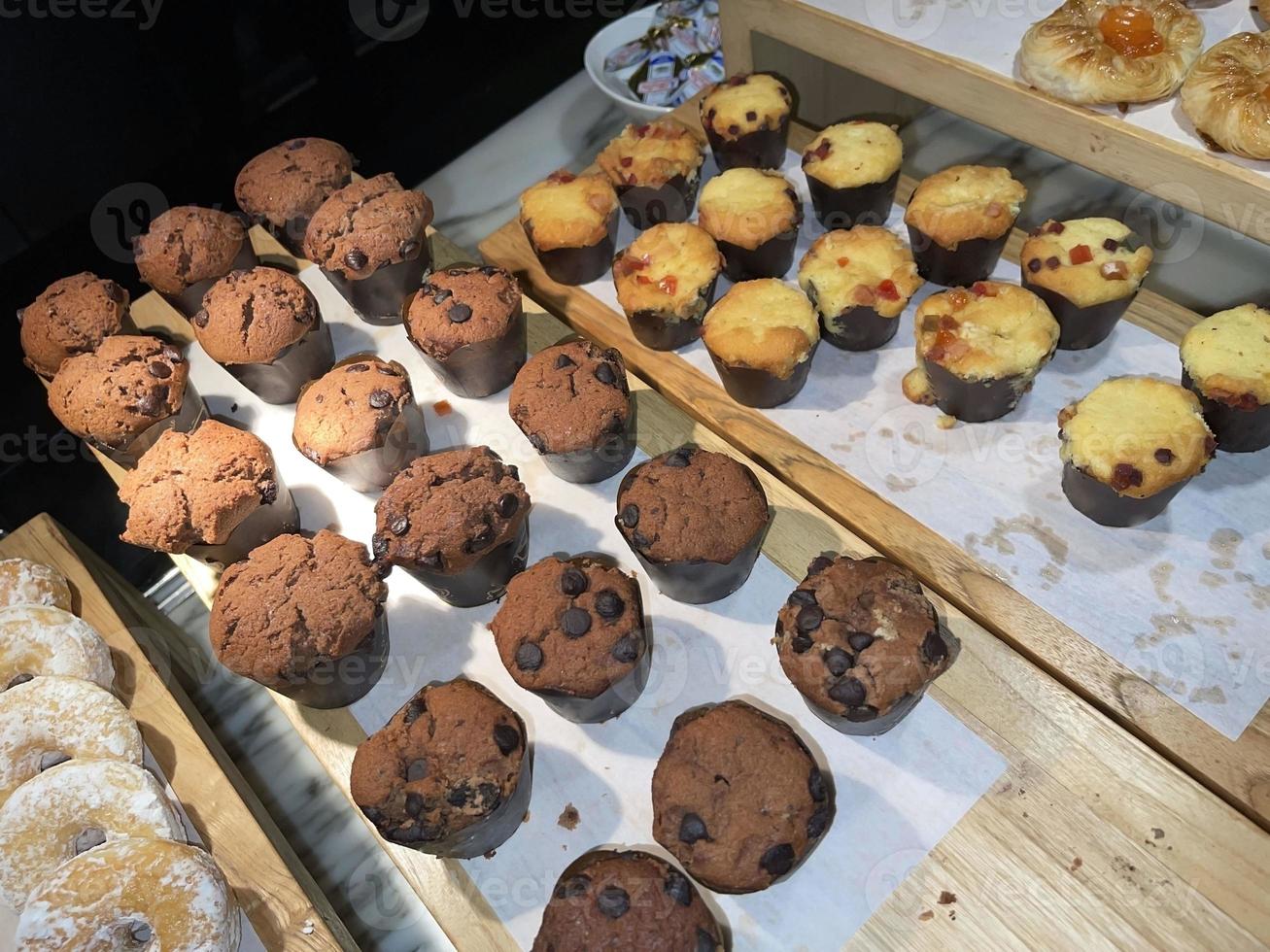 Lines of delicious chocolate and vanilla muffins Freshly baked homemade chocolate chip muffins photo