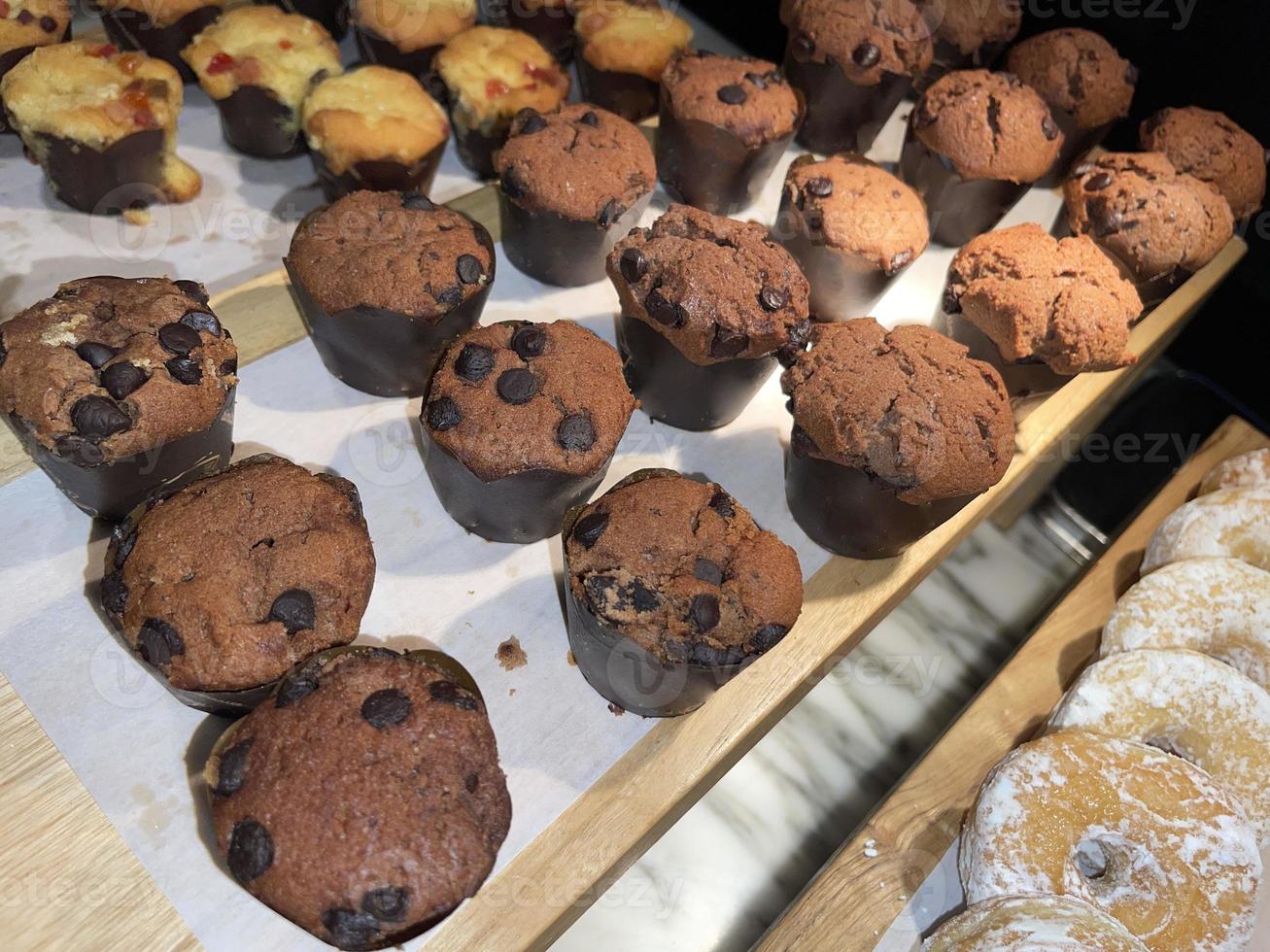 Lines of delicious chocolate and vanilla muffins Freshly baked homemade chocolate chip muffins photo