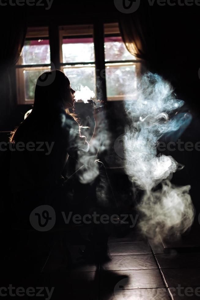 The girl smoke electronic cigarette photo