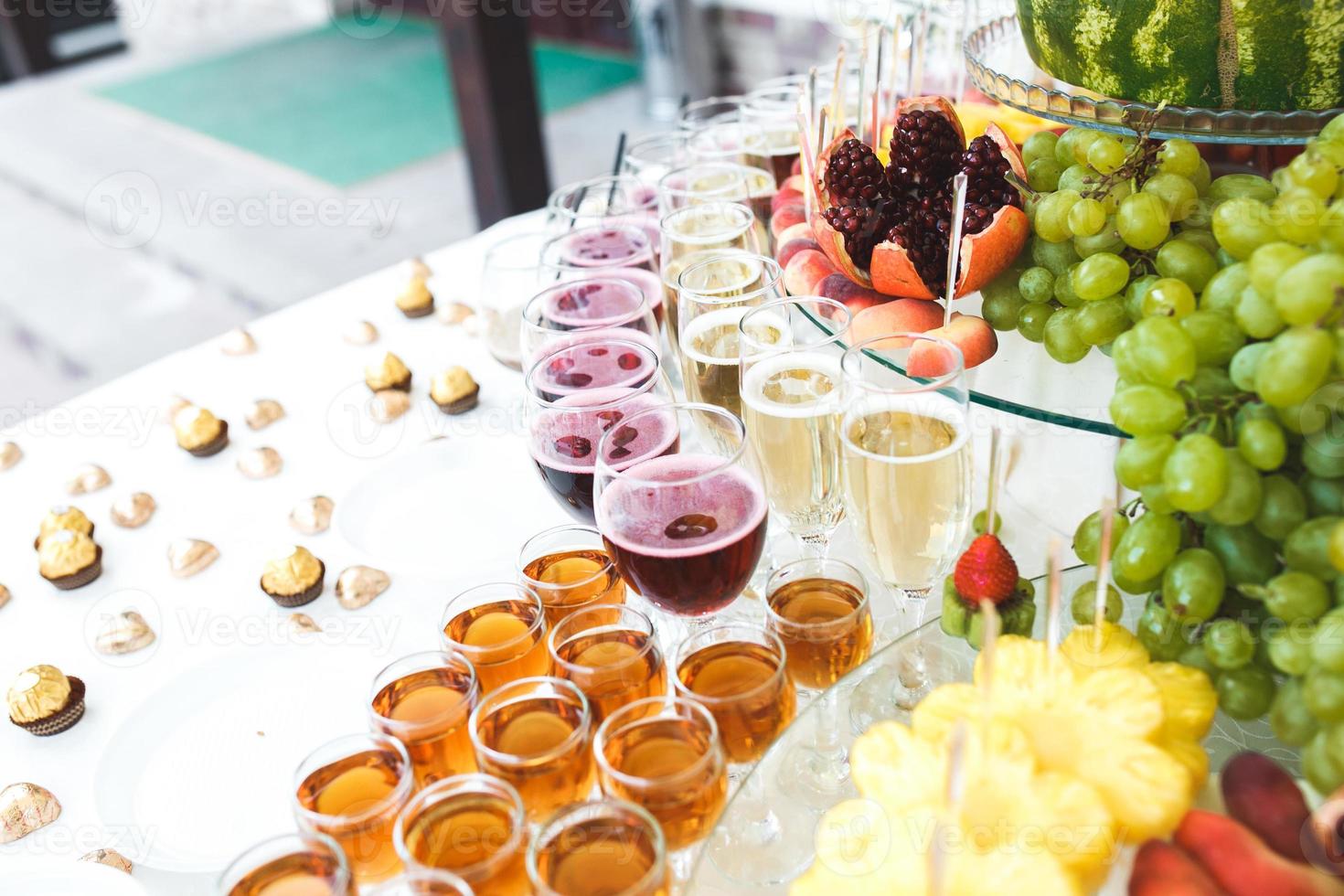 rich buffet, whiskey, bourbon, champagne, wine and fruit. photo