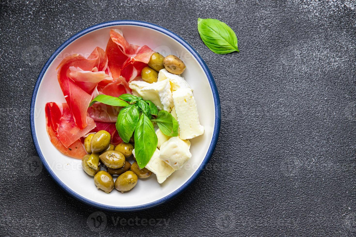 meat platter or cheese platter jamon, cheese, olives healthy meal food snack on the table copy space food background photo