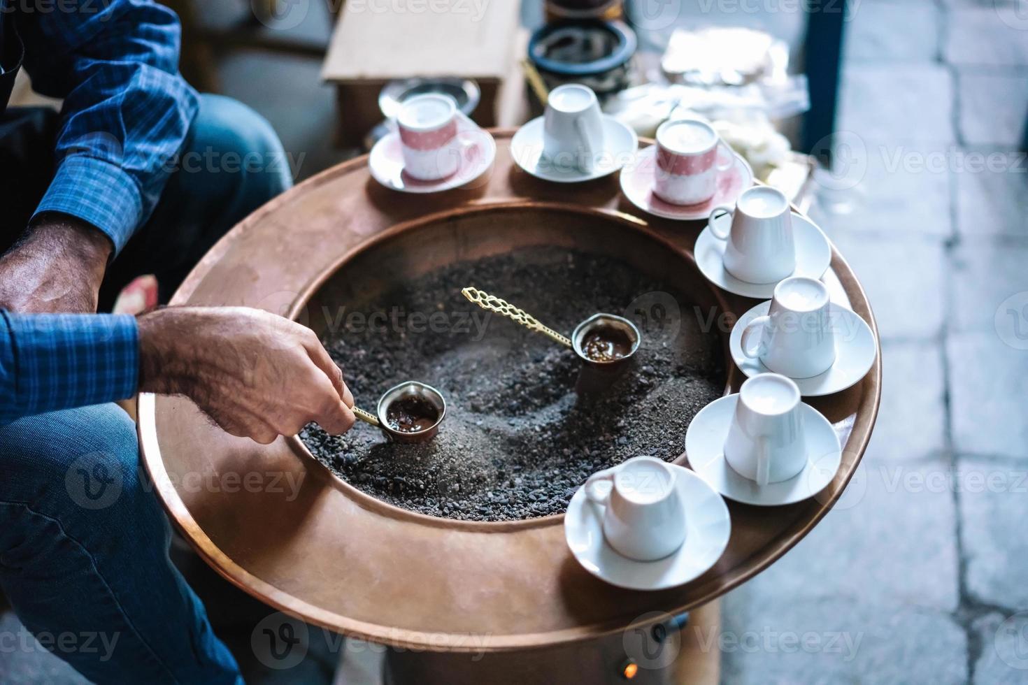 A man make Turkish coffee photo