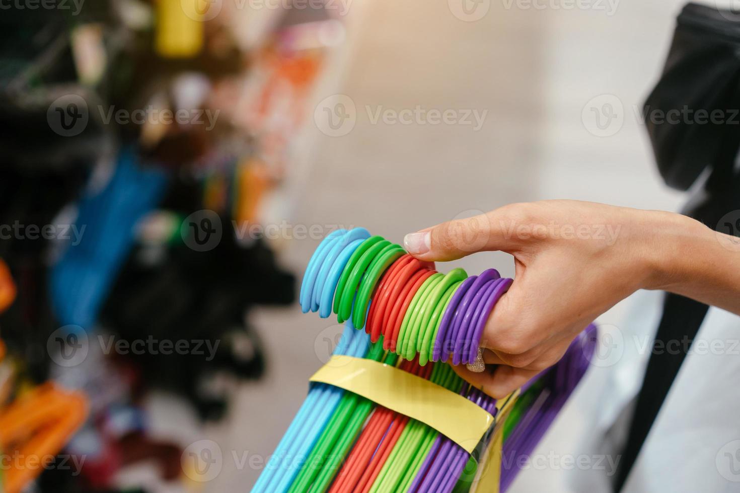 Female hand holding a set of hangers photo